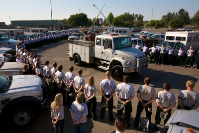 Firefighters line the route of a procession Friday at the Lithia Motors Amphitheater at the Jackson County Fairgrounds near Medford, Ore., to honor nine men killed in a helicopter crash. (Associated Press / The Spokesman-Review)
