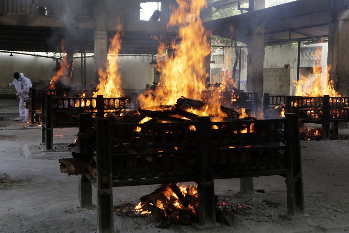 Flames rise from cremation pyres of victims of a fire that broke out in Vijay Vallabh COVID-19 hospital, at Virar, near Mumbai, India, Friday, April 23, 2021. A fire killed 13 COVID-19 patients in a hospital in western India early Friday as an extreme surge in coronavirus infections leaves the nation short of medical care and oxygen.  (Rajanish Kakade)