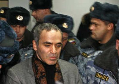 
Former chess champion Garry Kasparov is escorted by riot police minutes after he was sentenced to five days in jail for organizing an illegal protest in Moscow on Saturday. Associated Press
 (Associated Press / The Spokesman-Review)