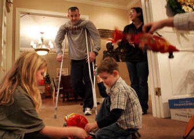 
Don Oakes, center,  is being treated at Madigan Army Medical Center at Fort Lewis, Wash., for an injury incurred in Iraq. Oakes is staying at the Fisher House with his wife, Sora Oakes, right, and 4-year-old son Connor, foreground right. Associated Press
 (Associated Press / The Spokesman-Review)