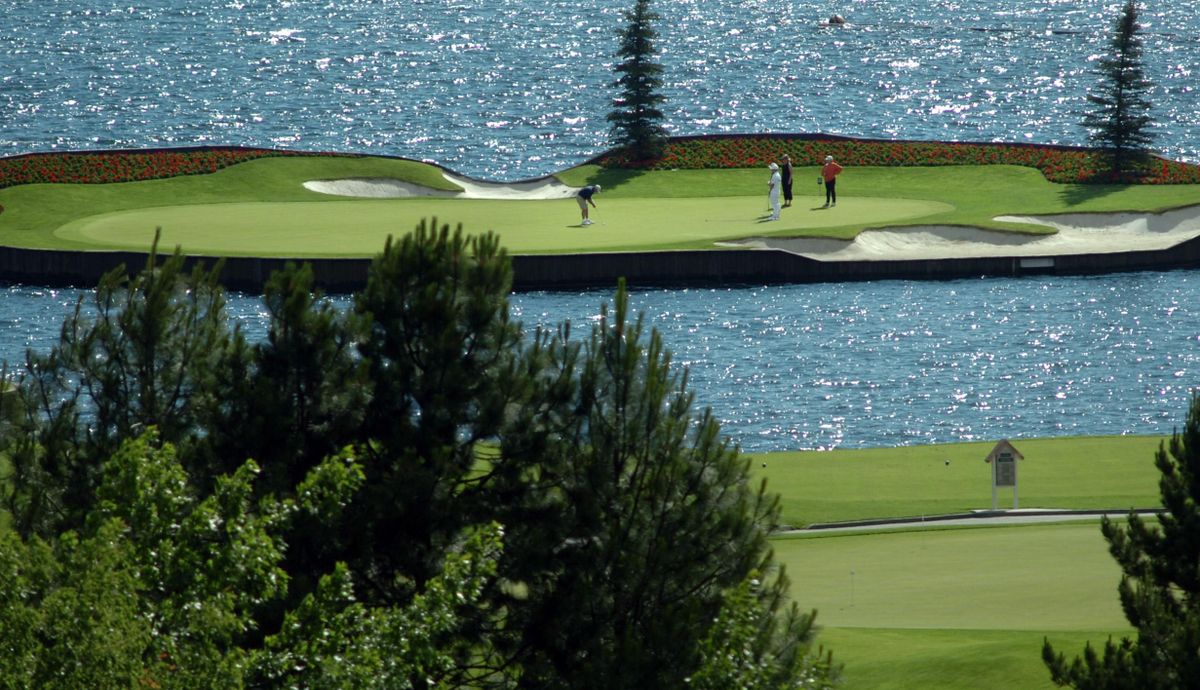 Golfers putt in on the immaculate floating green at the Coeur d’Alene Resort Golf Course on June 17, 2006. (Jesse Tinsley / The Spokesman-Review)