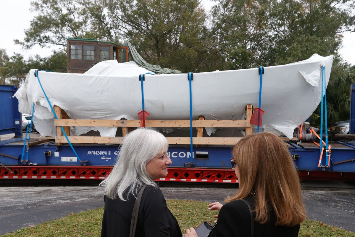 In December, Irene Weiss, former Florida Holocaust Museum board chair, left, and Debbie Sembler, of Pinellas Park, watch a Danish boat that helped Jewish families escape the Holocaust, get transported into a warehouse, where it will be restored at Elite Exterior Restoration. (Jefferee Woo/Tampa Bay Times/TNS)  (Jefferee Woo/Tampa Bay Times/TNS)