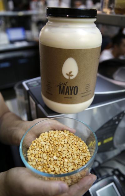 Hampton Creek Foods CEO Josh Tetrick holds a bowl of a species of yellow pea used to make Just Mayo, a plant-based mayonnaise, in San Francisco. (Associated Press)