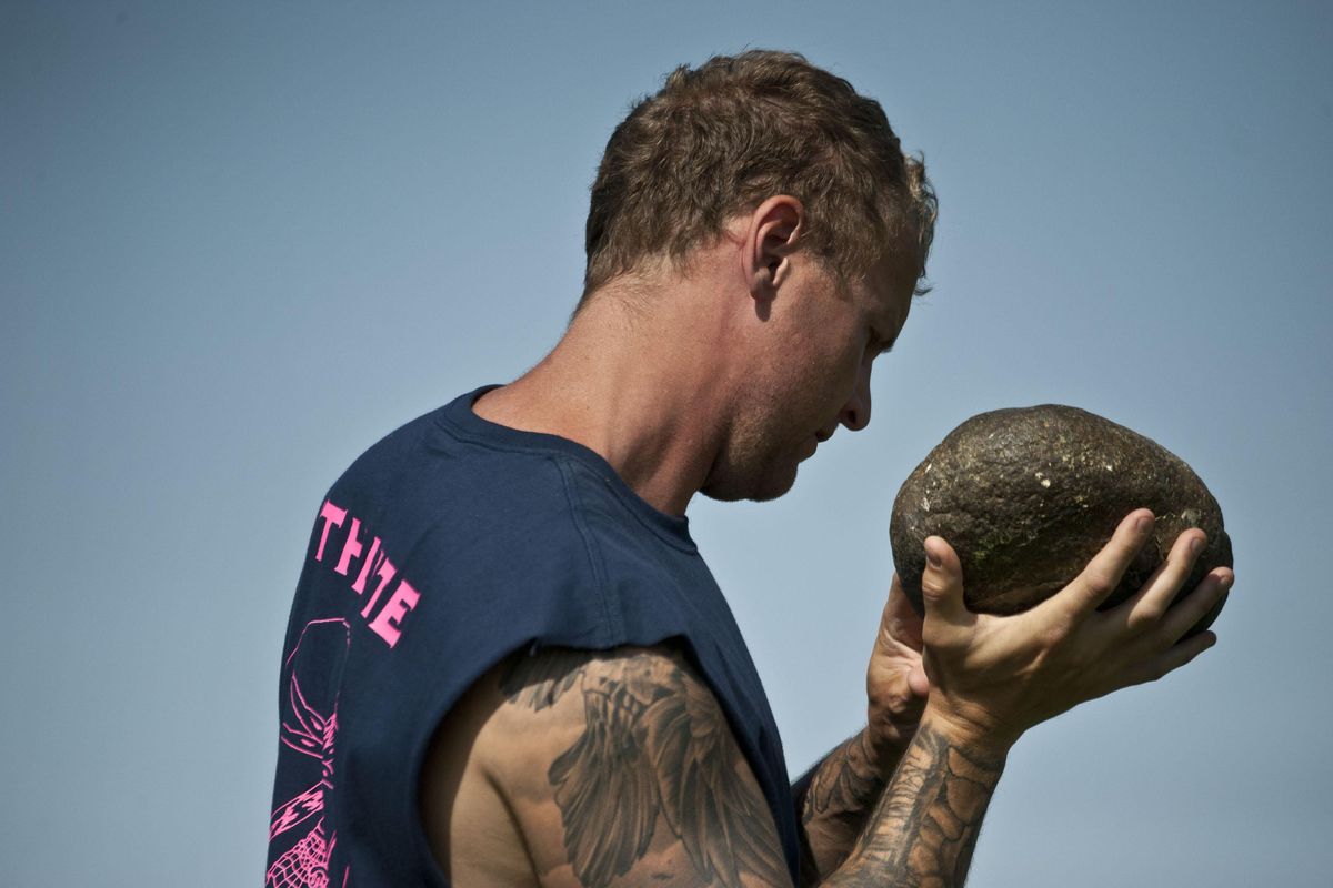 Thomas Hedlund of Elma,Wa prepares to throw the Braemar Stone during competition at the Spokane Scottish Highland Games on Saturday, August 3, 2019 at the Spokane County Fairgrounds. (Kathy Plonka / The Spokesman-Review)