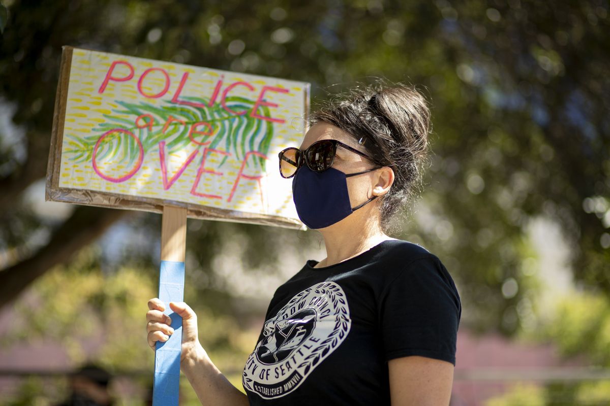 Protestors block Fourth Avenue outside Seattle City Hall and listen to Monday
