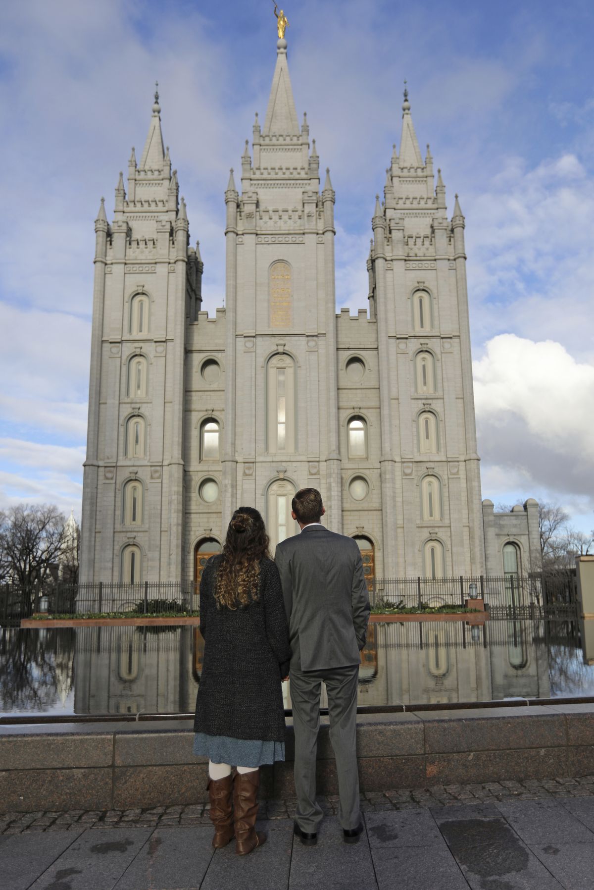 FILE - In this April 6, 2019, file photo, a couple looks at the Salt Lake City temple during the The Church of Jesus Christ of Latter-day Saints