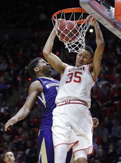 Utah forward Kyle Kuzma, right, dunks against Washington forward Marquese Chriss, rear, during the second half during an NCAA college basketball game Wednesday, Feb. 10, 2016, in Salt Lake City. Utah won 90-82. (Rick Bowmer / Associated Press)