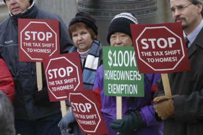 
From left, Billie Dixon, Sue Chew and Roger Sherman demonstrate outside the state Capitol in Boise on Tuesday to protest the tax burden on homeowners in the state. 
 (Associated Press / The Spokesman-Review)