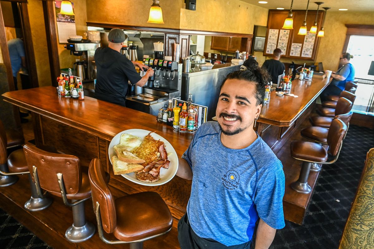 Dolly’s Café server Adrian Amaya delivers the Hardy Breakfast to a customer Sept. 21.  (DAN PELLE/THE SPOKESMAN-REVIEW)