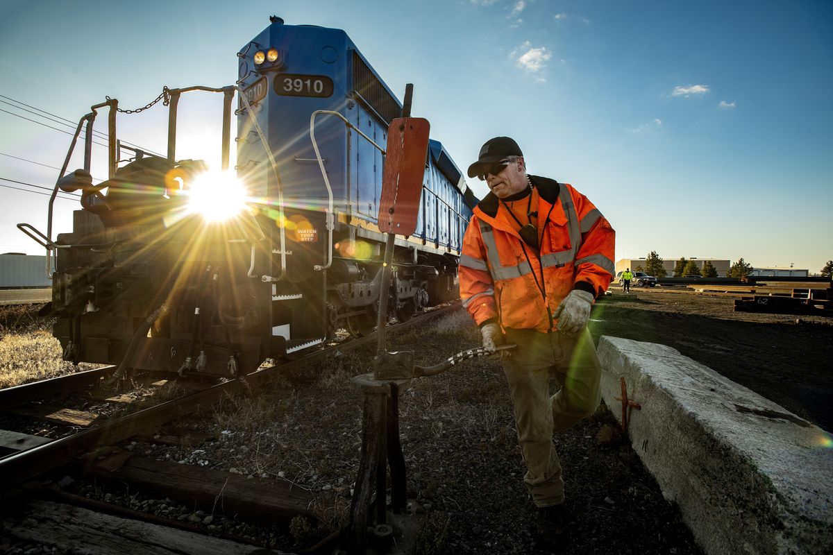 Washington Eastern Railroad conductor Scott Rohrig switches tracks on the Geiger Spur along West McFarlane Road, Friday, Nov. 16, 2018. The West Plains PDA is laying down framework to attract large aerospace and manufacturing companies to the area. The airport received a $2 million grant to a build a mile of rail from the Geiger Spur to the airport, which makes plans for a proposed transload facility closer to reality. (Colin Mulvany / The Spokesman-Review)