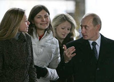 
Russian President Vladimir Putin talks with voters at a polling station Sunday in Moscow. Associated Press
 (Associated Press / The Spokesman-Review)