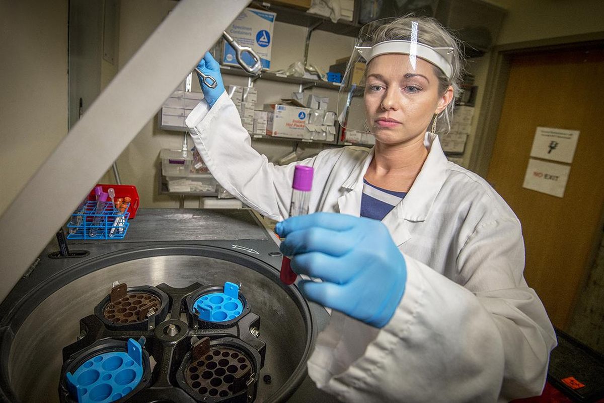 Study co-author Elena Skornyakov loads a blood sample into the cold centrifuge at the sleep laboratory at WSU Health Sciences Spokane. (WSU photo)