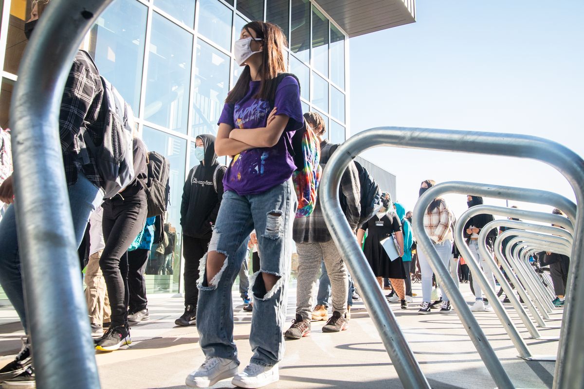 Students advance to enter the brand-new Shaw Middle School building on the first day of the 2021-2022 school year on Thursday, Sept. 2. Students are masked and in-person for classroom learning in the Spokane Public School District.  (Libby Kamrowski/ THE SPOKESMAN-R)