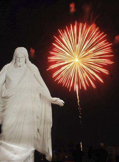 In this June 29, 2011, file photo, a cardboard cutout of Christ stands outside the Idaho Center amphitheater as fireworks light up the night sky at the conclusion of the God and Country Family Festival in Nampa, Idaho. The Idaho Attorney General's Office says it's illegal for the general public to buy aerial fireworks, which require a special permit to use. The opinion that became public Tuesday, June 27, 2017, appears to conflict with a common practice allowing the sale of aerial fireworks in Idaho to the general public as long as buyers promise not to use them in Idaho. (Charlie Litchfield / Associated Press)
