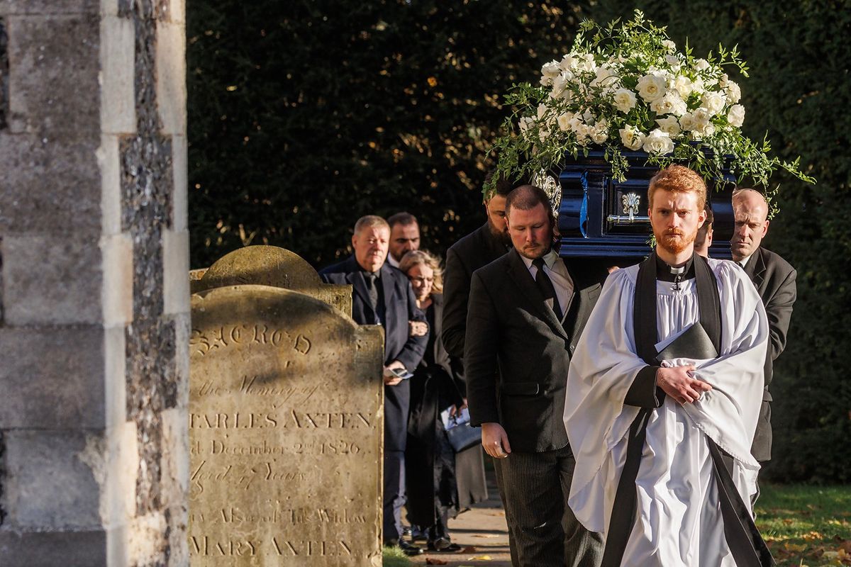 A priest leads the coffin out following the funeral of singer Liam Payne, former member of One Direction, on Wednesday in Amersham, England.  (Dan Kitwood/Getty Images North America/TNS)