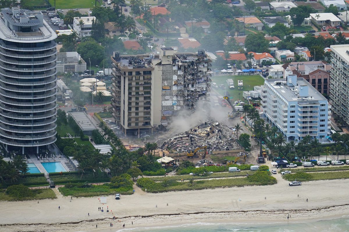 FILE - In this Friday, June 25, 2021, file photo, rescue personnel work in the rubble at the Champlain Towers South Condo, in Surfside, Fla. Even as the search continues over a week later for signs of life in the mangled debris of the fallen Champlain Towers South, the process of seeking answers about why it happened and who is to blame is already underway in Florida's legal system.  (Gerald Herbert)