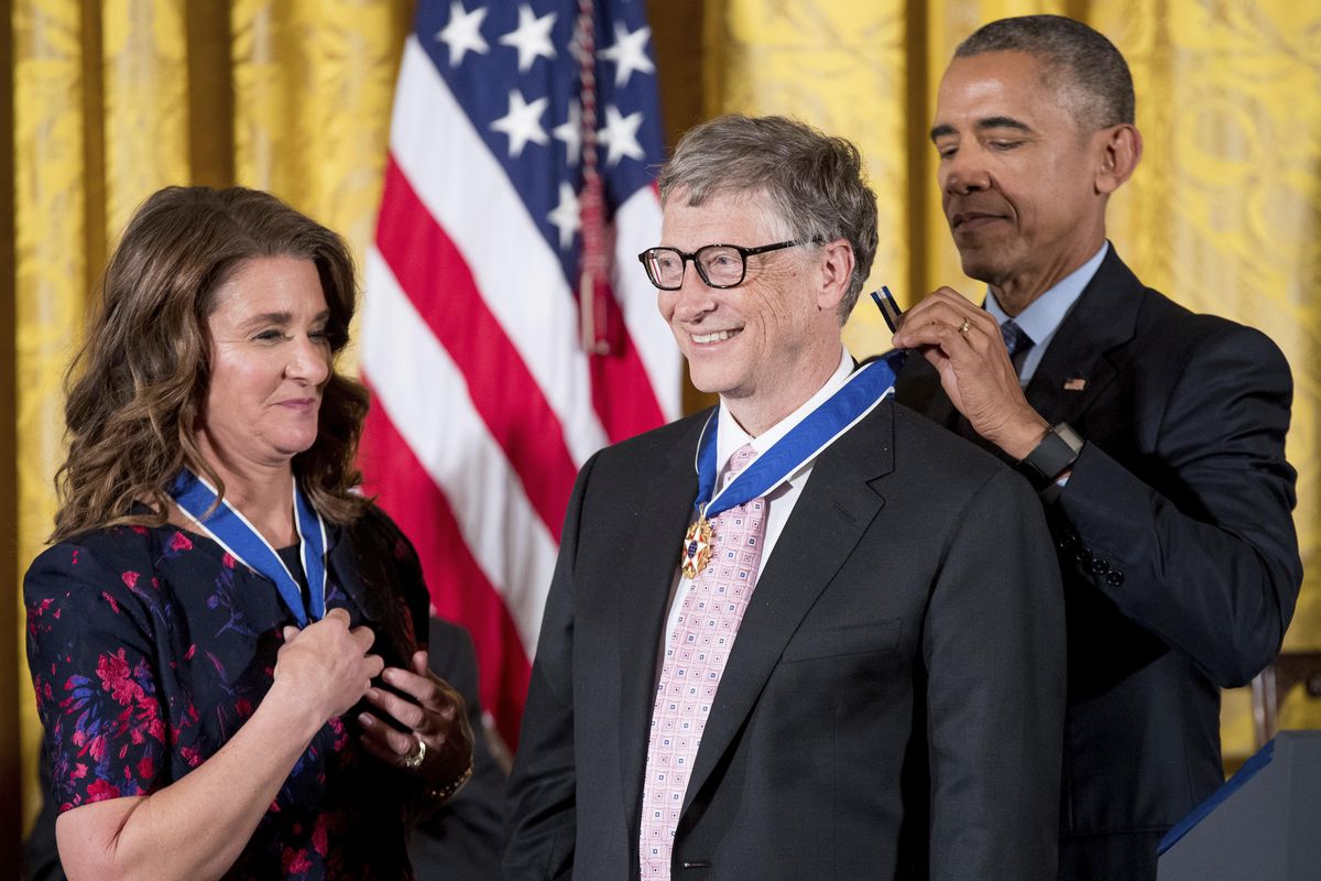 President Barack Obama, accompanied by Melinda Gates,  presents the Presidential Medal of Freedom to Bill Gates during a ceremony in the East Room of the White House on Tuesday in Washington. (Andrew Harnik / Associated Press)