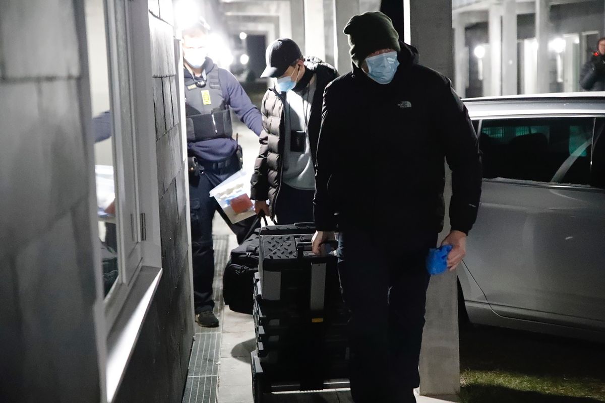 Danish police officers work at Apotekerhaven in Holbaek, Denmark, on Saturday Feb. 6, 2021, as Danish police search addresses in Apotekerhaven. A number of people have been arrested in Denmark over an alleged terror attack plot, as part of a larger case with connections to Germany.  (presse-fotos.dk)