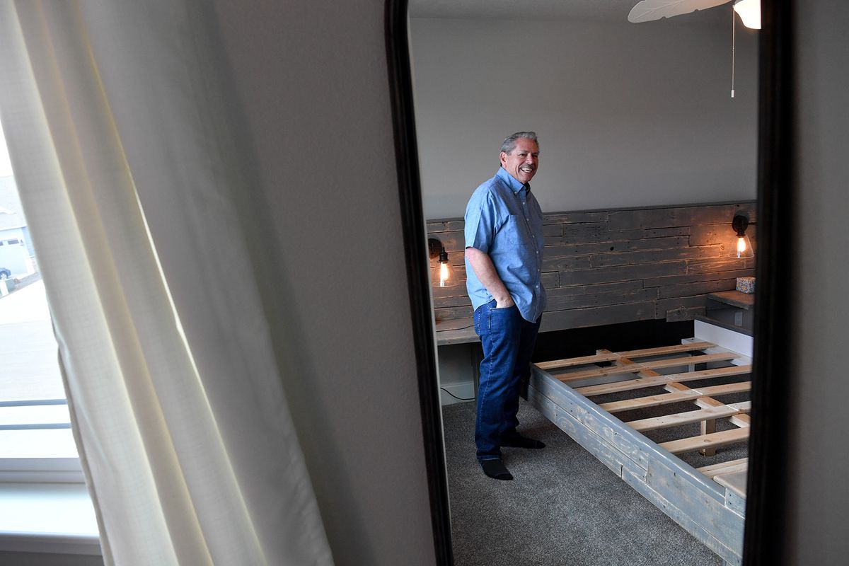 Steve Spurrier shows off a bed frame he built during the Covid-19 lockdown out of 90% reclaimed wood from the housing development he lives in on Wednesday, March 10, 2021, at his home in Greenacres, Wash.  (Tyler Tjomsland/The Spokesman-Review)