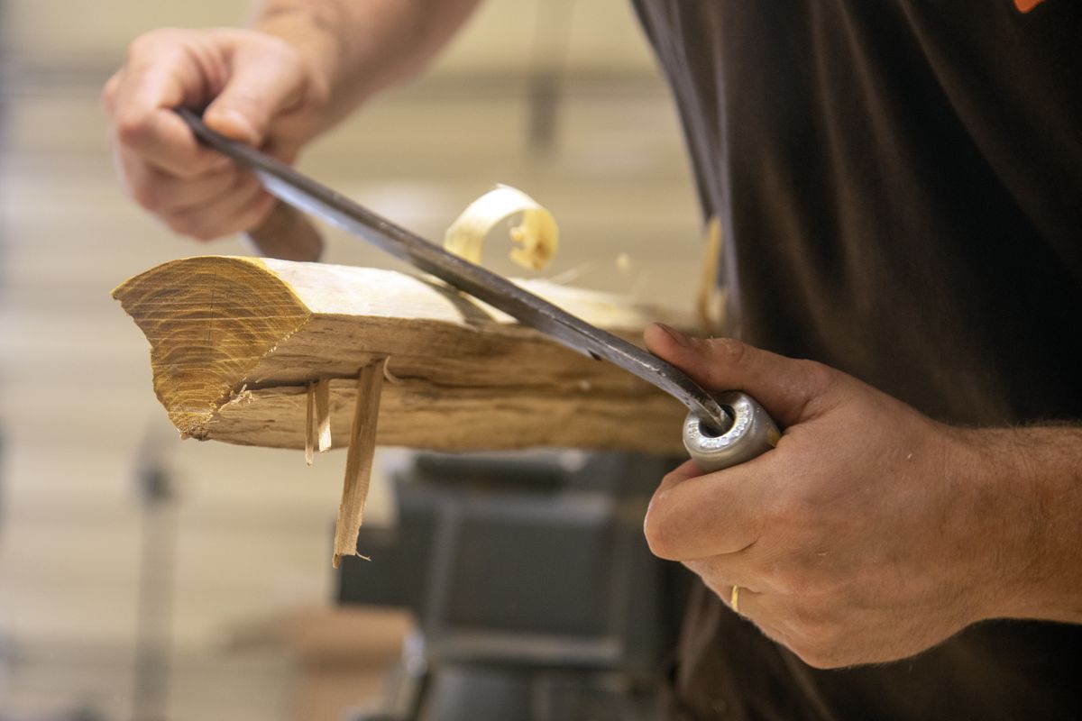 David Young shaves wood that will become one of his custom made recurve bows in his shop which is south of Spokane, shown Thursday, June 25, 2026.  (Michael Wright/The Spokesman-Review)