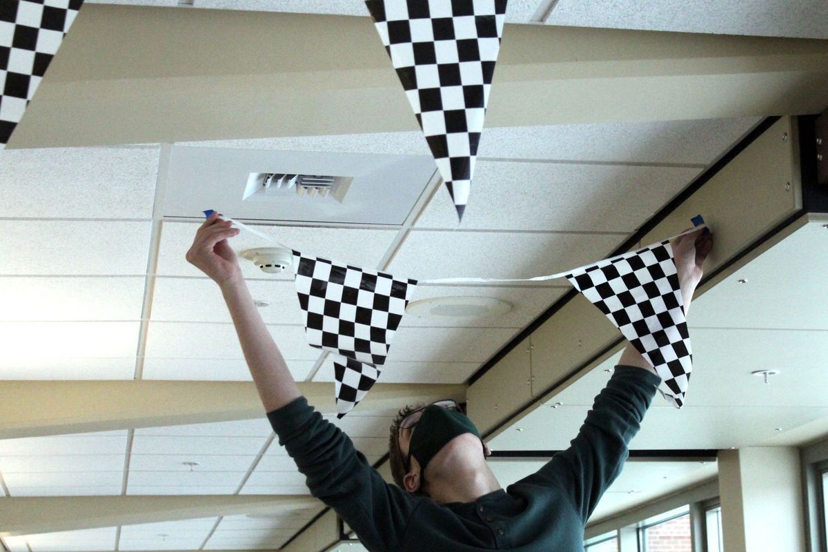 Shadle Park High School junior Cameron Burns help during the early stages of decorating on Tuesday December 14, 2021.  (Jordan Tolley-Turner/The Spokesman-Review)