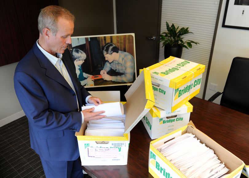 Portland attorney Kelly Clark examines some of the 14,500 pages of previously confidential documents created by the Boy Scouts of America concerning child sexual abuse within the organization, in preparation for release of the documents. (Associated Press)