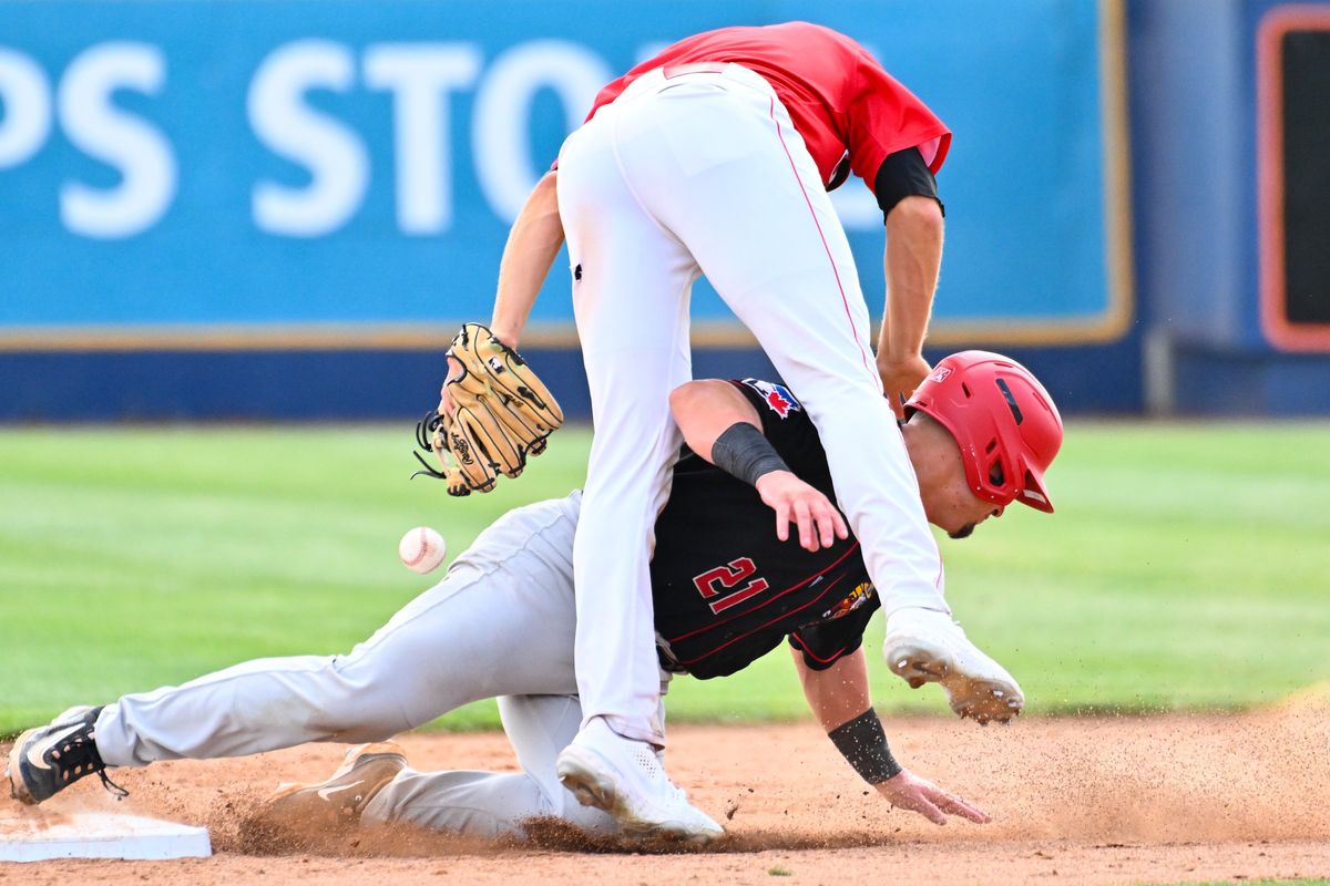 Vancouver’s Andres Sosa slides safely into second base while Spokane second baseman Nic Kent covers the bag during the opener of Tuesday’s Northwest League doubleheader at Avista Stadium.  (Tyler Tjomsland/The Spokesman-Review)