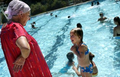 
Klavdia Verkovod laughs as her 2-year-old granddaughter, Dianna Verkovod, shivers next to Liberty Pool on Friday afternoon. 
 (Holly Pickett / The Spokesman-Review)