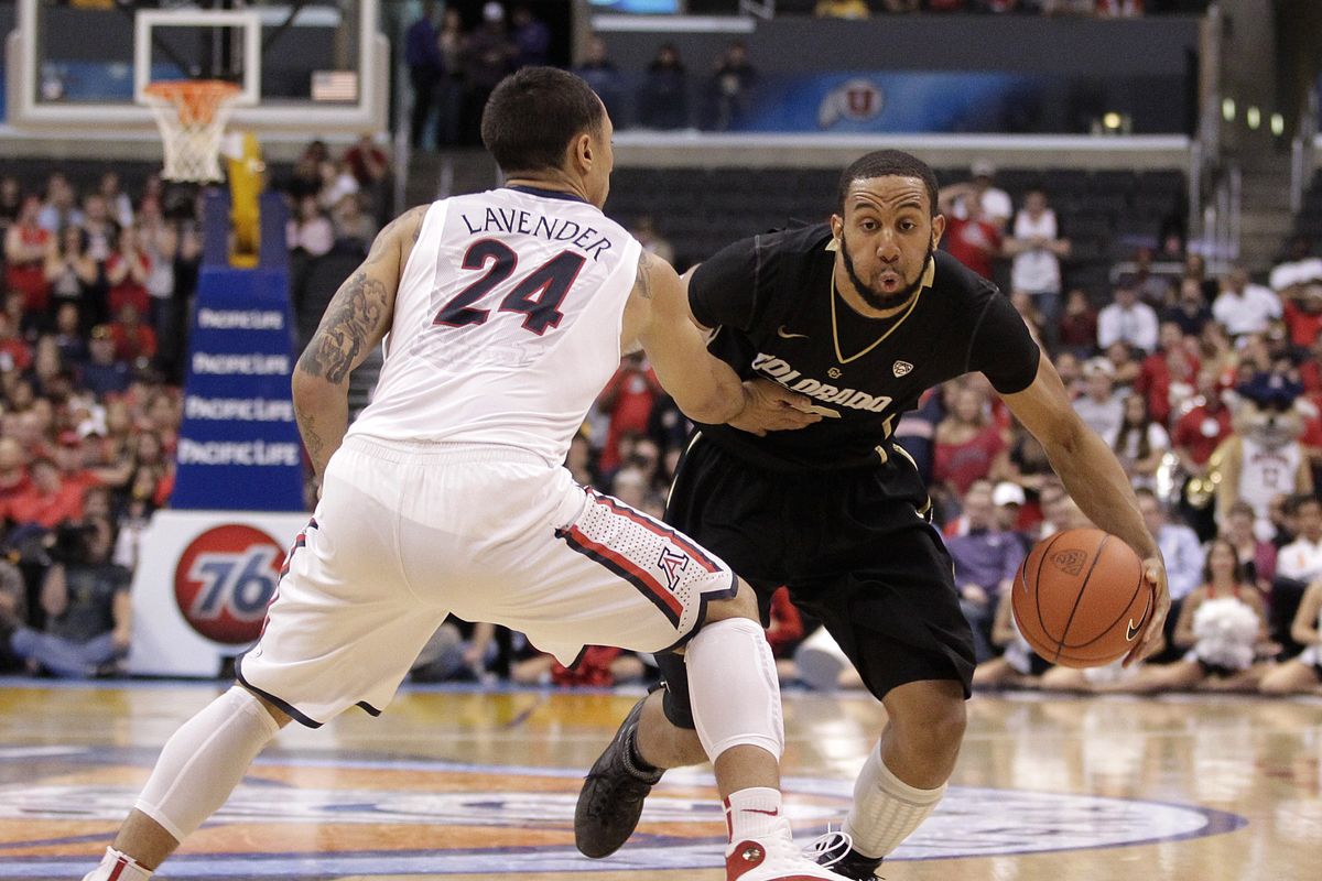 Colorado’s Carlon Brown is defended by Arizona’s Brendon Lavender. Brown scored 13 points in the win. (Associated Press)
