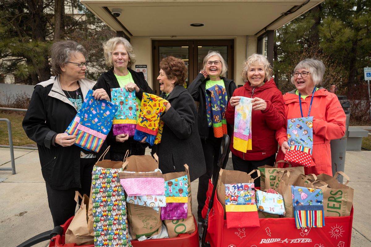 These women, from left, Betty Higley, Mishia Osborn, Cherry Edwards, Jackie Boardman, Janet Payne and Joyce Beach, laugh while trying to pick a favorite pillow case. They have sewed thousands of colorful, custom pillow cases for the children staying at Providence Sacred Heart Children