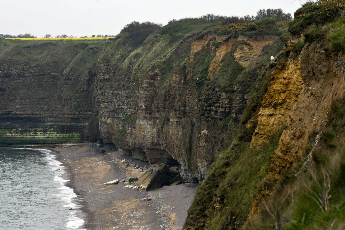 In this May 1, 2019, photo, the cliffside of Pointe du Hoc overlooking Omaha Beach in Saint-Pierre-du-Mont, Normandy, France. On June 6, 1944, U.S. Rangers scaled the coastal cliffs to capture a German gun battery. (Virginia Mayo / AP)