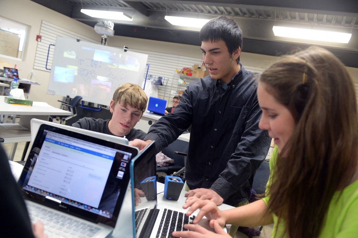 Aaron Johnston, Max Delsid and Michelle Kluss work on projects in a biomedical class at Mead School District’s Riverpoint Academy on Wednesday. The program uses project-based techniques, including hands-on experiences, community interaction and classroom instruction. (Jesse Tinsley)