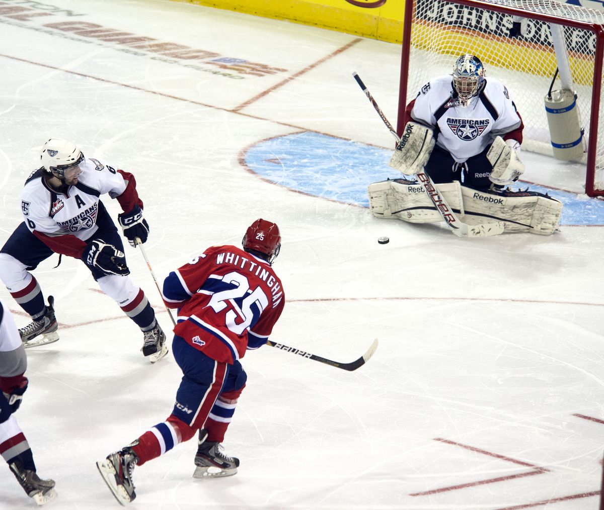 Spokane’s Riley Whittingham shoots against Tri-City netminder Eric Comrie during the first period. (Dan Pelle)