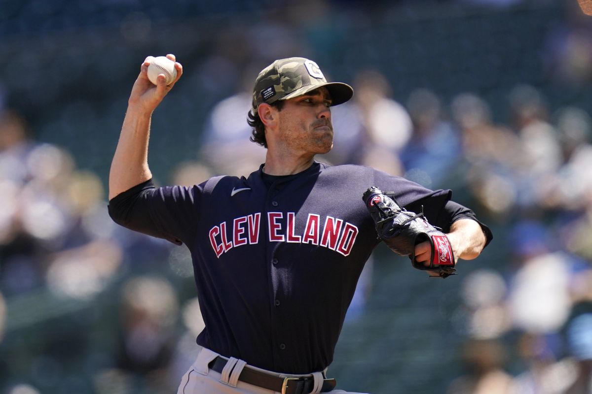 Cleveland Indians starting pitcher Shane Bieber throws against the Seattle Mariners in the first inning of a baseball game Sunday, May 16, 2021, in Seattle.  (Elaine Thompson)
