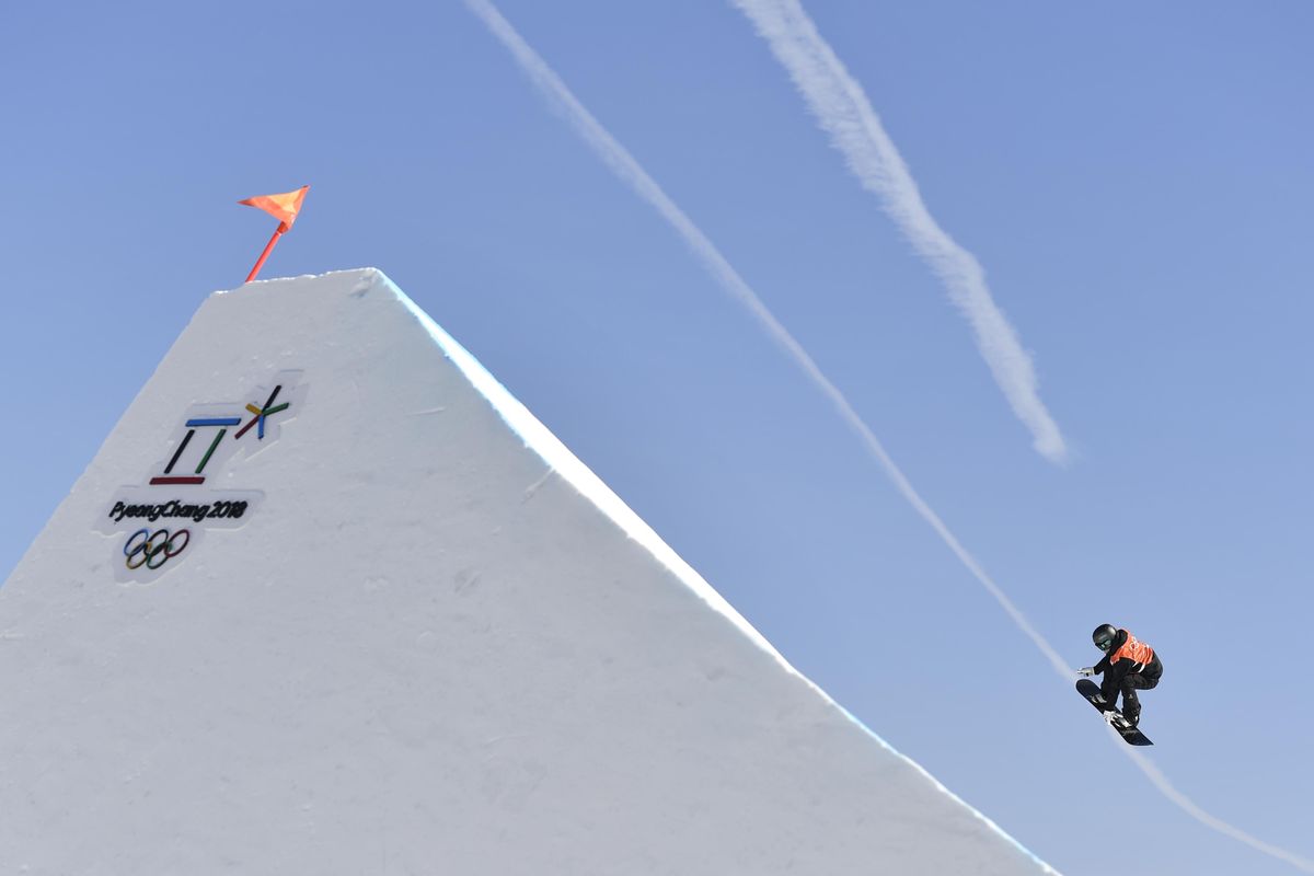 A snowboarder flies through the air during a women slopestyle training session Wednesday at the Phoenix Snow Park ahead of the 2018 Winter Olympics in Pyeongchang, South Korea. (Michal Kamaryt / Associated Press)