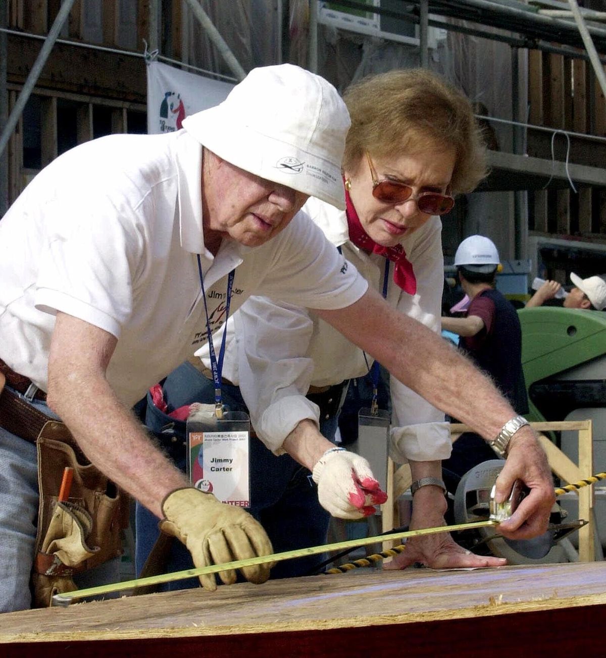 FILE - In this Aug. 6, 2001, file photo former U.S. President Jimmy Carter, left, and his wife Rosalynn help build a house for the Jimmy Carter Work Project 2001, at Asan near Chonan city, south of Seoul, South Korea. Jimmy Carter and his wife Rosalynn celebrate their 75th anniversary this week on Thursday, July 7, 2021. (YUN JAI-HYOUNG)