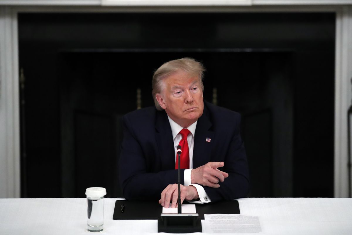 President Donald Trump listens during a roundtable with governors on the reopening of America