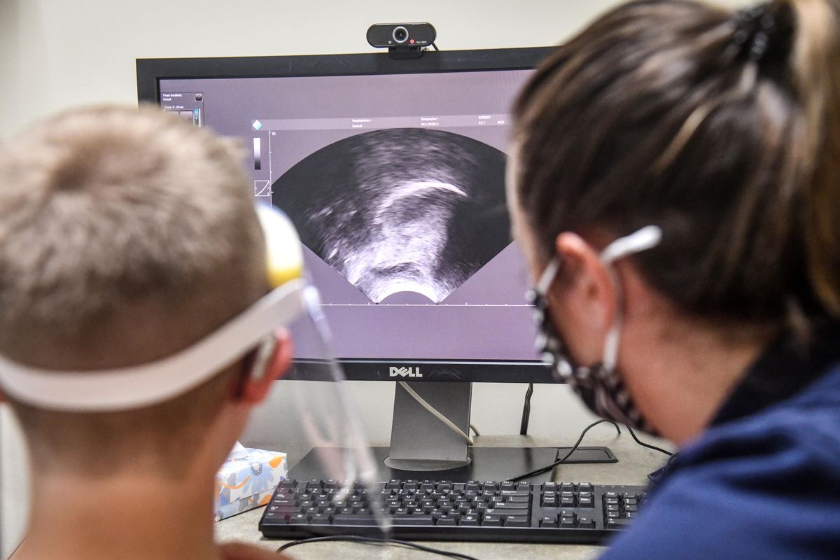 An ultrasound scan of Jack Felker’s throat and tongue shows him trying to produce the R sound for WSU grad student clinician Randi Petersen during a session at the Eastern Washington University’s Health Sciences Building in Spokane.  (Dan Pelle/THE SPOKESMAN-REVIEW)