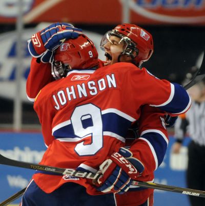 Spokane Chiefs' Taylor Johnson and Brenden Kichton embrace after Kichton scored a goal against Prince George. (Jesse Tinsley / The Spokesman-Review)