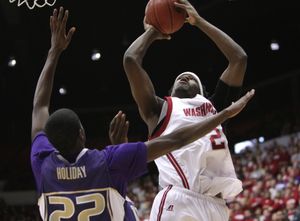 WSU forward DeAngelo Casto shoots against  Justin Holiday of the Huskies. (Tyler Tjomsland / The Spokesman-Review)