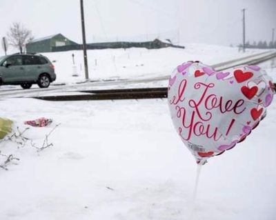 Flowers and balloons are being left where a fatal accident occurred when a train hit a car crossing the tracks at Spokane Street near Prairie Avenue in Post Falls early Tuesday morning. (Lisa James/Coeur d'Alene Press)
