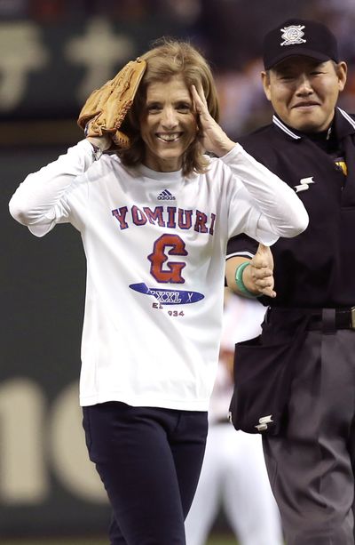 U.S. Ambassador to Japan Caroline Kennedy reacts after throwing out the ceremonial first pitch before the Japan’s Central League professional baseball opening game at Tokyo Dome in Tokyo on Friday. (Associated Press)