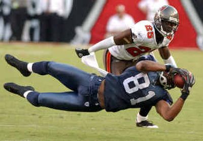 
Seahawks wide receiver Koren Robinson goes horizontal to pull in a fourth-quarter pass in front of Buccaneers cornerback Brian Kelly on Sunday. 
 (Associated Press / The Spokesman-Review)