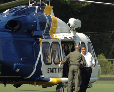 New Jersey Gov. Chris Christie, right, exits a state helicopter to attend his son's high school baseball game in Montvale, N.J., on Tuesday. (Associated Press)