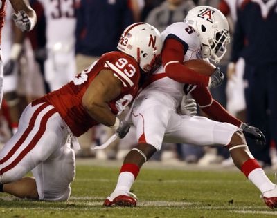 Nebraska defensive tackle Ndamukong Suh drags down Arizona quarterback Matt Scott.  (Associated Press)
