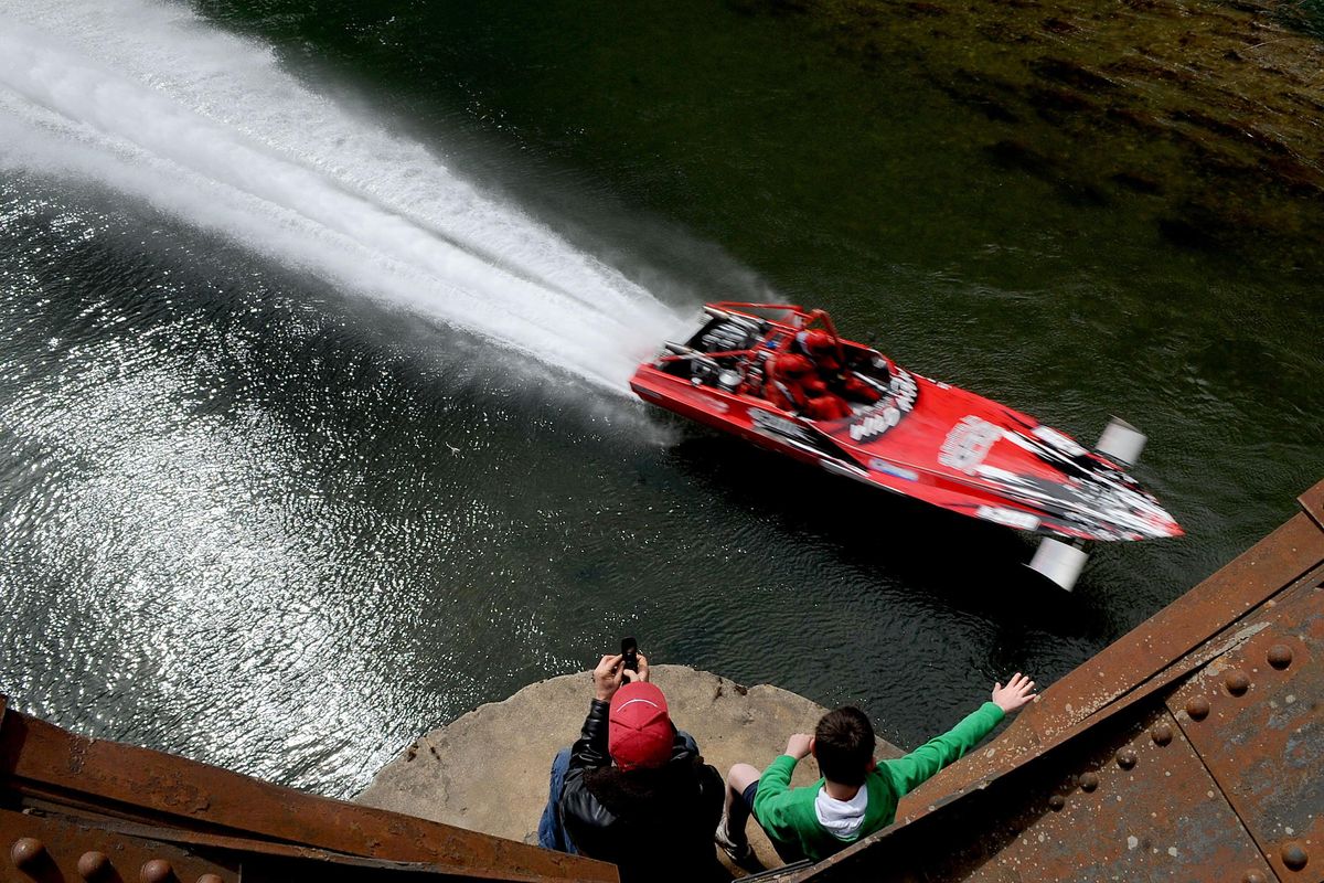 Paul Brebner, left, of St. Maries,  and Logan Dianda, 10 of Medical Lake, watch the 2012 World Jet Boat Races from a railroad bridge April 15, 2012, above the St. Joe River in St. Maries. (Kathy Plonka / The Spokesman-Review)