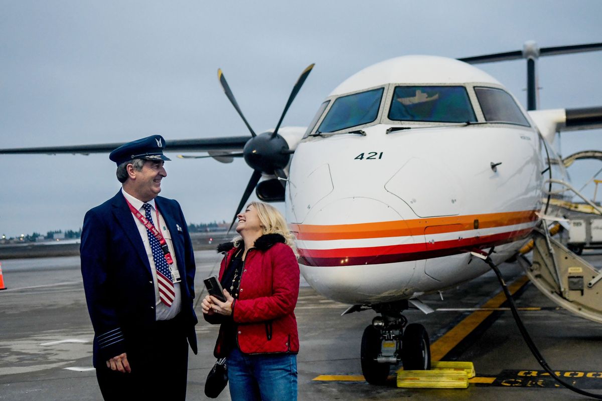 Horizon Air pilot Alan Dutton and his wife, former flight attendant Lola Dutton, share a laugh as Alaska Airlines Q400 turboprop prepares for its final flight out of Spokane International Airport on Thursday.  (Kathy Plonka/The Spokesman-Review)