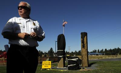 The Coeur d’Alene Fire Department’s  Glenn Lauper  stands at Fallen Heroes Memorial Plaza.  (Kathy Plonka / The Spokesman-Review)