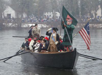 
Re-enactor James Gibson, center, waves to spectators as he portrays Gen. George Washington, during the 53rd Christmas Day crossing of the Delaware River on Sunday. 
 (Associated Press / The Spokesman-Review)