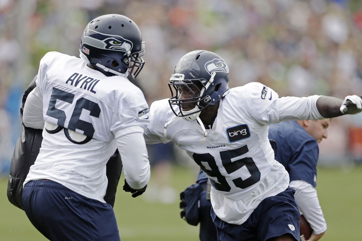Seattle defensive ends Benson Mayowa, right, and Cliff Avril run through a drill at practice. (Associated Press)